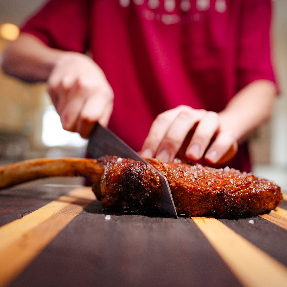 American Wagyu cowboy ribeye steak with impressive bone-in presentation, rich marbling, and bold flavor - perfect for grilling