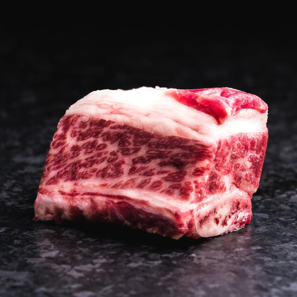 American Wagyu bone-in short ribs with rich marbling and hearty flavor, ideal for braising, smoking, or slow cooking