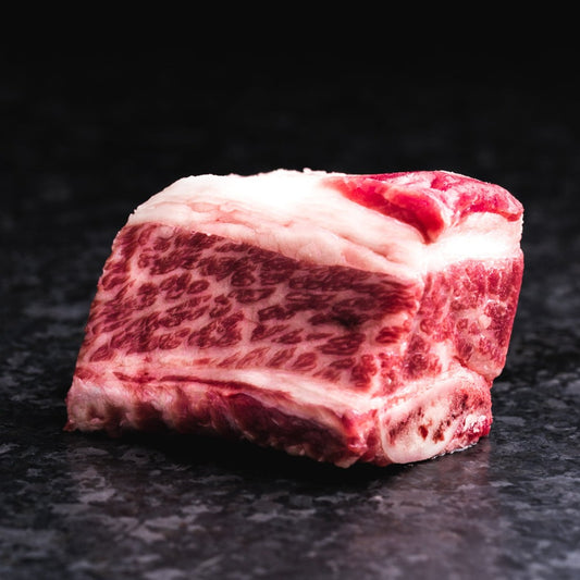 American Wagyu bone-in short ribs with rich marbling and hearty flavor, ideal for braising, smoking, or slow cooking