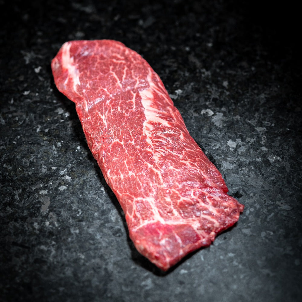 American Wagyu flat iron steak with tender texture and rich marbling, perfect for grilling or pan-searing