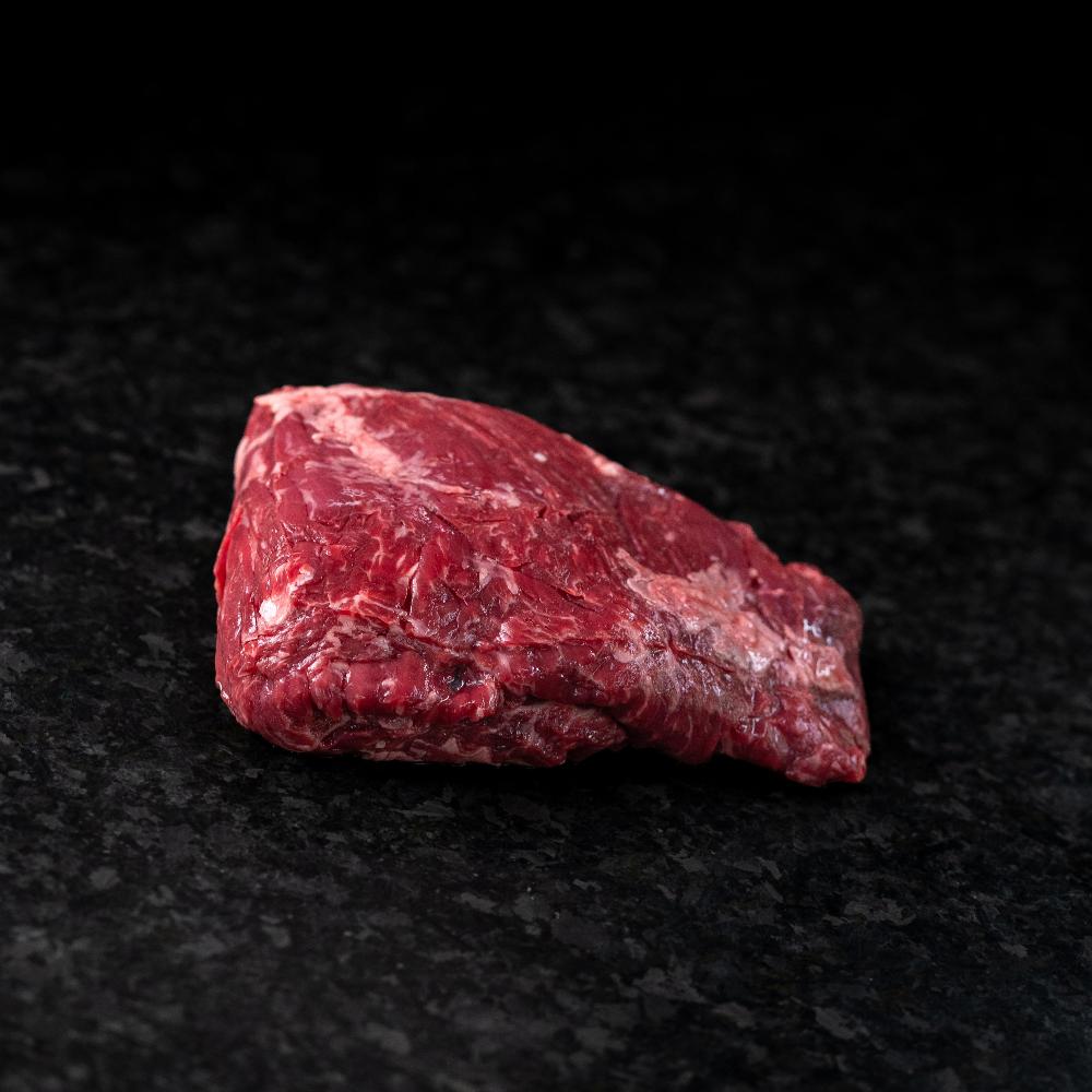 American Wagyu sirloin flap steak with loose grain and rich marbling, ideal for marinating, grilling, or slicing thin