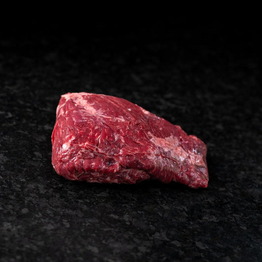 American Wagyu sirloin flap steak with loose grain and rich marbling, ideal for marinating, grilling, or slicing thin