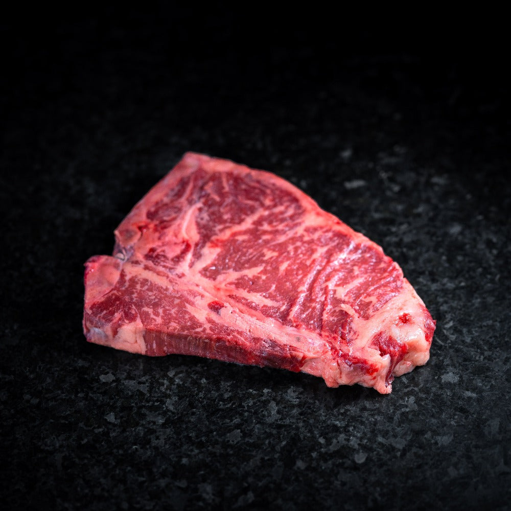 American Wagyu T-Bone steak with signature bone-in cut, tender filet and strip combo, perfect for grilling