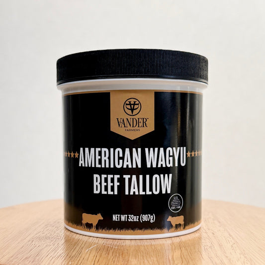 Jar of American Wagyu Beef Tallow with Vander Farmers logo on a light wooden surface.